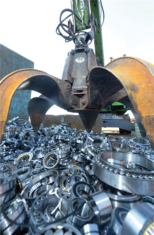Photo courtesy Shaeffler AG. A big claw was used to lift the fake bearings into a scrap press.